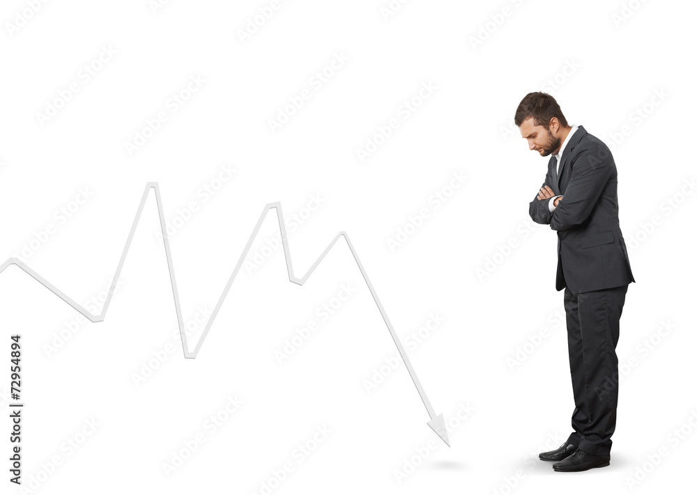 man looking at downturn graph man looking at downturn graph