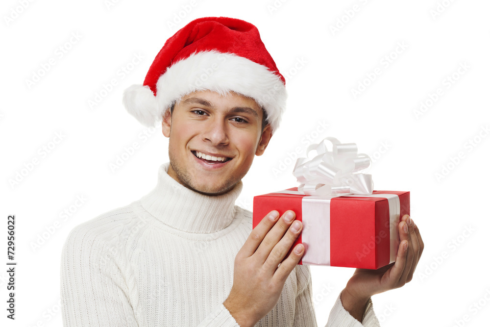 Happy boy with santa hat holding a gift Happy boy with santa hat holding a gift
