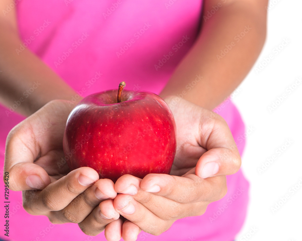 Girl hands holding a red apple over white background Girl hands holding a red apple over white background