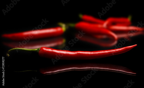 Studio shot of chilli peppers on black photo