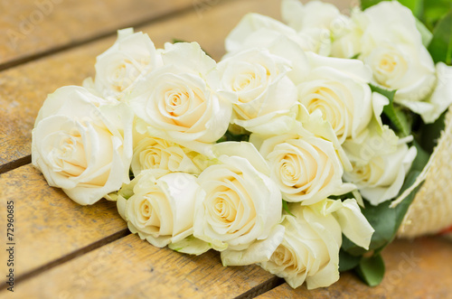 Beautiful bouquet of white roses on the floor