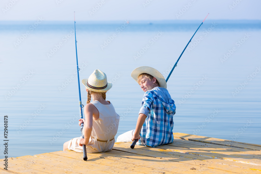 Boy and girl with fishing rods