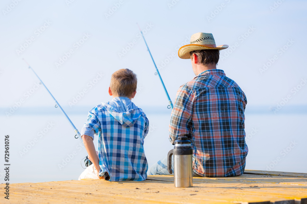 boy and his father fishing togethe boy and his father fishing togethe