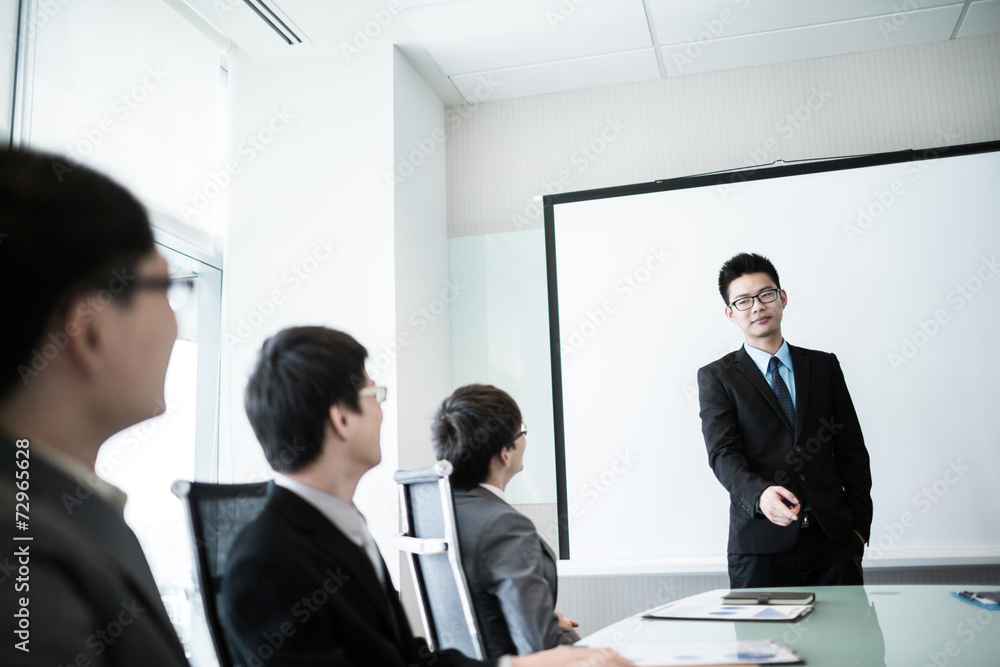 businessman giving a presentation to his colleagues businessman giving a presentation to his colleagues