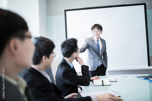 Wallpaper Mural businessman giving a presentation to his colleagues Torontodigital.ca