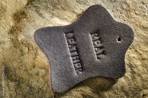 Close up of leather tag on aged paper background