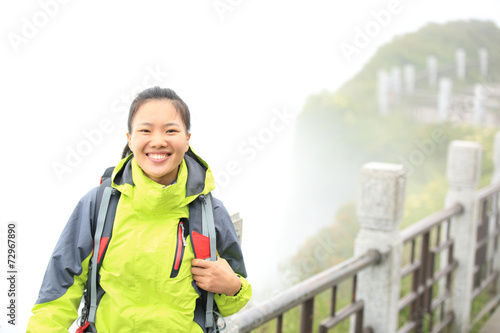 young woman hiker enjoy the view at emei mountain peak  photo