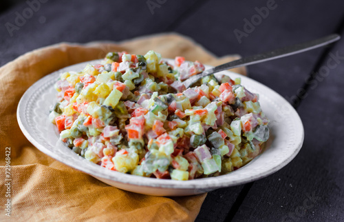 Russian traditional salad olivier with pea in the plate