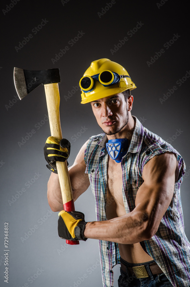 Ripped muscular builder man with tools Ripped muscular builder man with tools