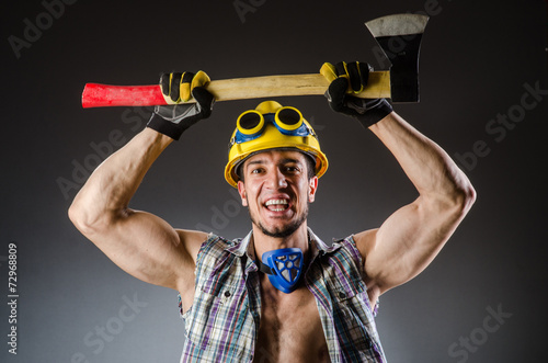 Ripped muscular builder man with tools © Elnur