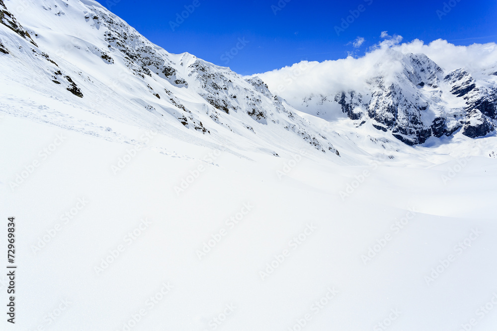 Winter mountains, ski run in Italian Alp