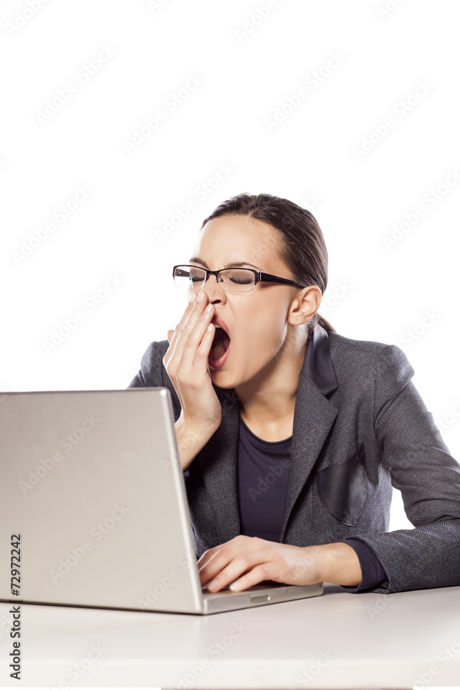 sleepy business woman sitting at the desk next to her laptop sleepy business woman sitting at the desk next to her laptop