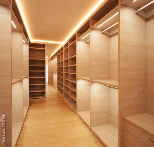 Elegant wooden walk-in closet ( mostly for women ) photo