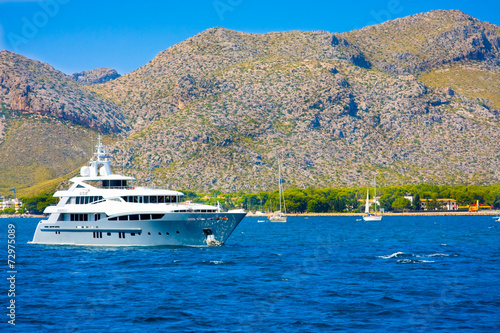 Ship against mountains of Port de Pollenca, Mallorca