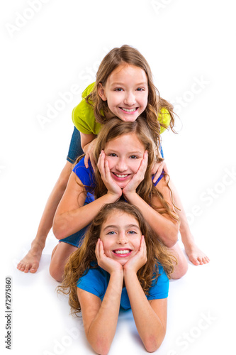 Three kid girls friends happy stacked in a row