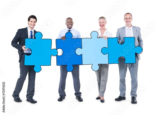 Group of Business People Holding Puzzle Pieces