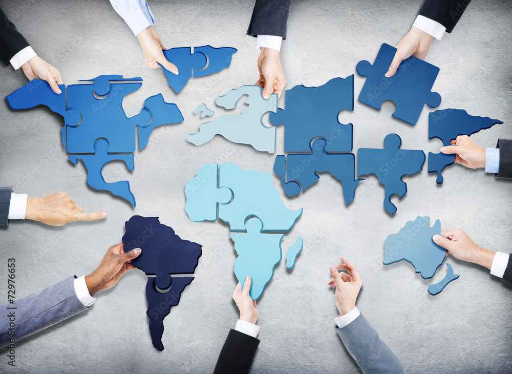 Business People with Jigsaw Forming in World Map