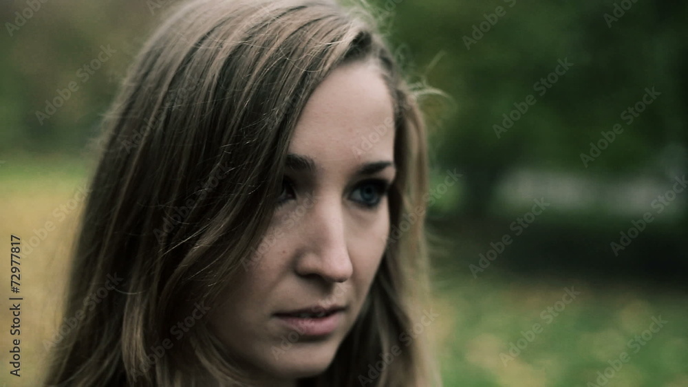Portrait of sad young beautiful woman in the park Portrait of sad young beautiful woman in the park