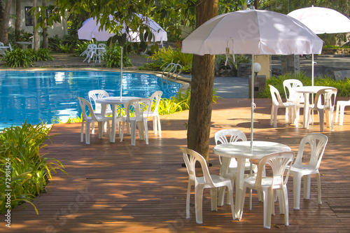 white plastic garden furniture table and chairs summer evening -