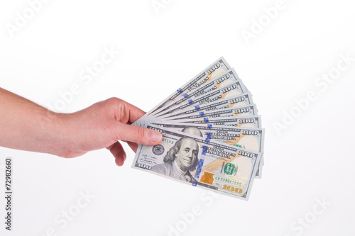 Hand holding dollar bills.