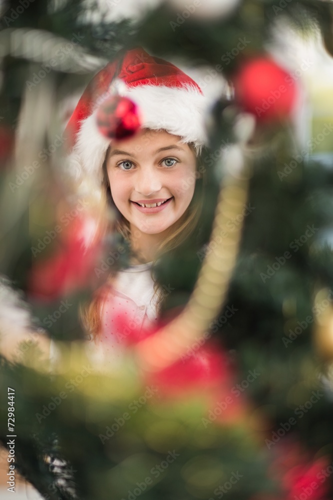 Festive litte girl decorating christmas tree Festive litte girl decorating christmas tree