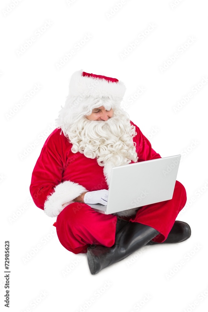 Santa sitting and using his laptop Santa sitting and using his laptop