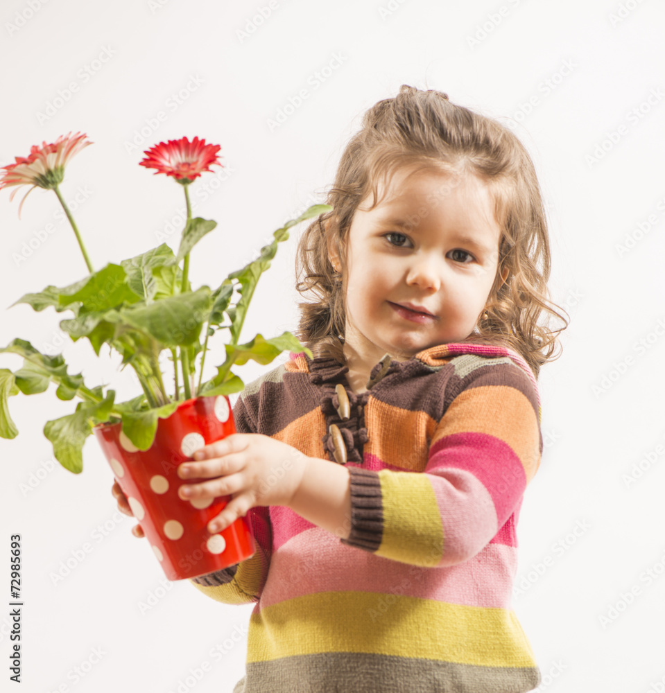Portrait of a beautiful little girl holding vase with flowers Portrait of a beautiful little girl holding vase with flowers