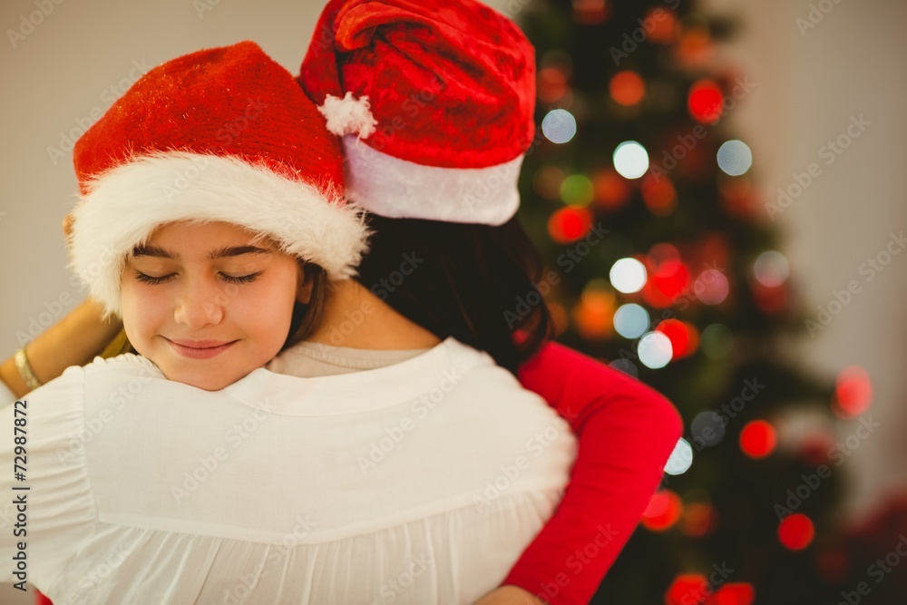 Mother and daughter hugging at christmas Mother and daughter hugging at christmas