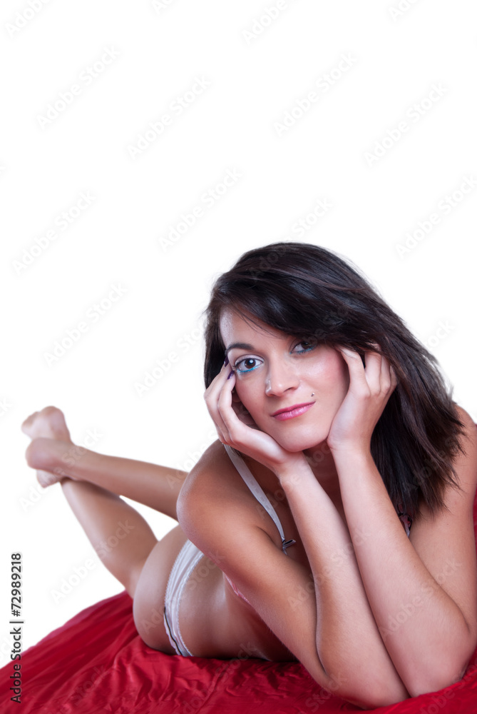 Fit woman in lingerie lying on a red blanket