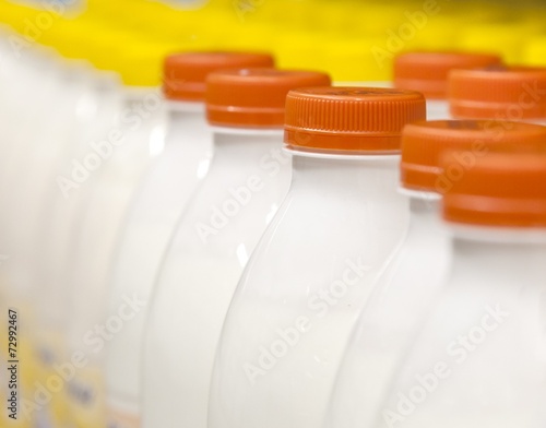 Rows with bottles of milk on the supermarket shelves