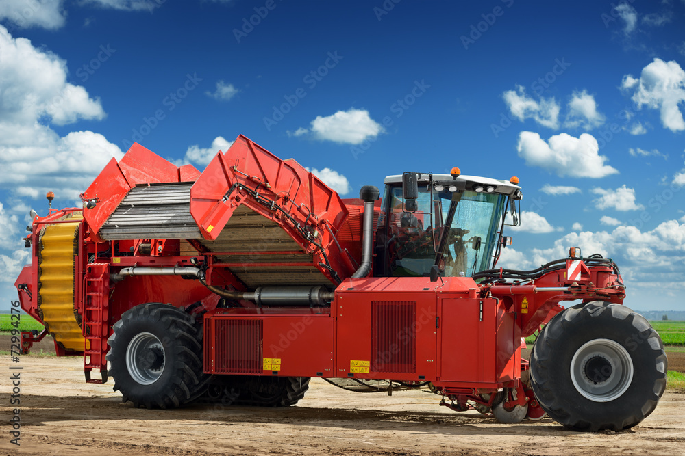 Potato harvester machine on the field Potato harvester machine on the field