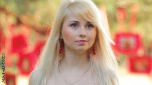 Blonde girl walk in forest with red memories on background photo