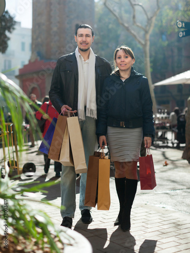 man and girl with purchases at street