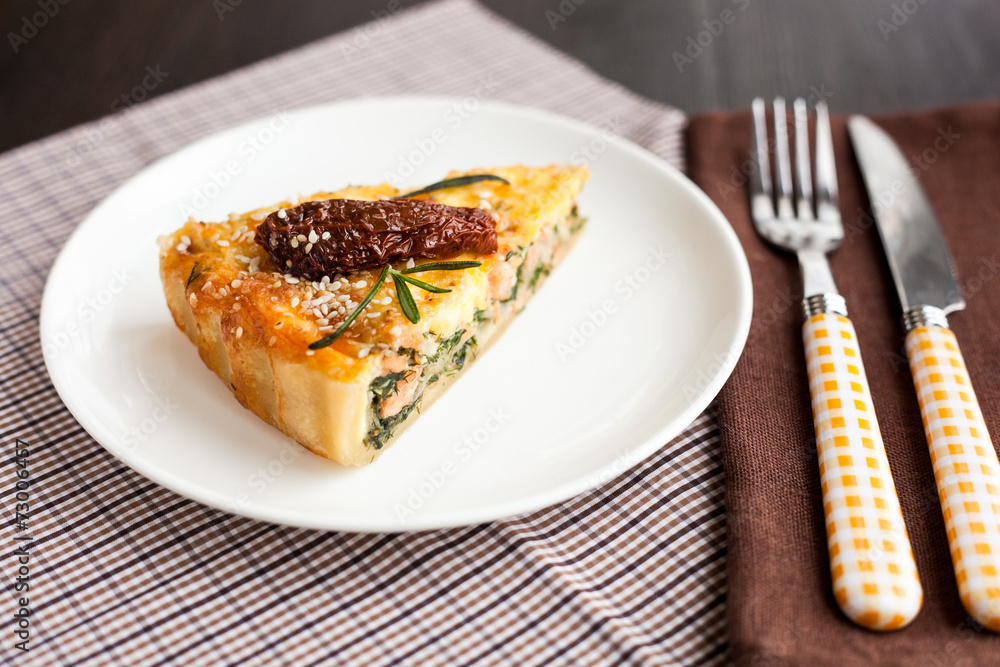 Piece of pie with spinach and fish salmon Piece of pie with spinach and fish salmon