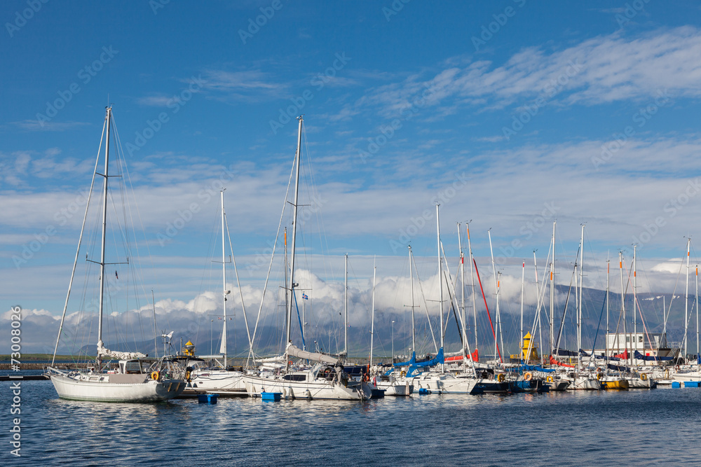 Yachts near the pier on the background of mountains