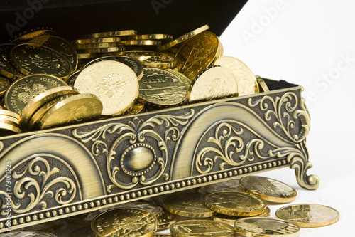 gold casket and gold coins on a white background