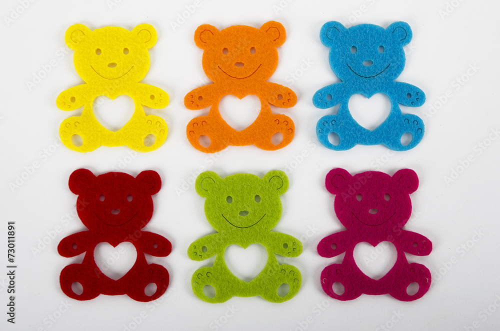 Six colorful teddy bear decorations over white background