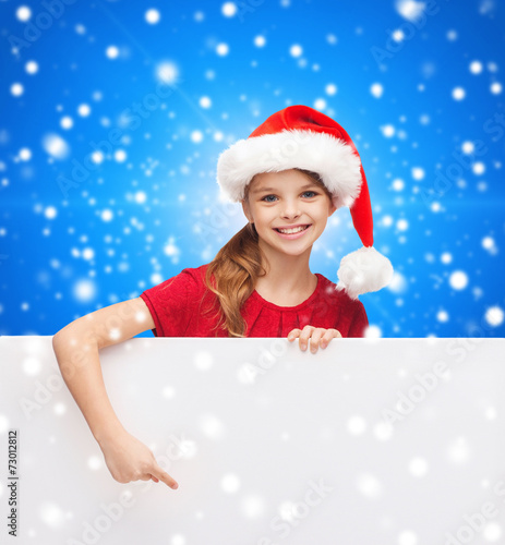 girl in santa helper hat with blank white board © Syda Productions