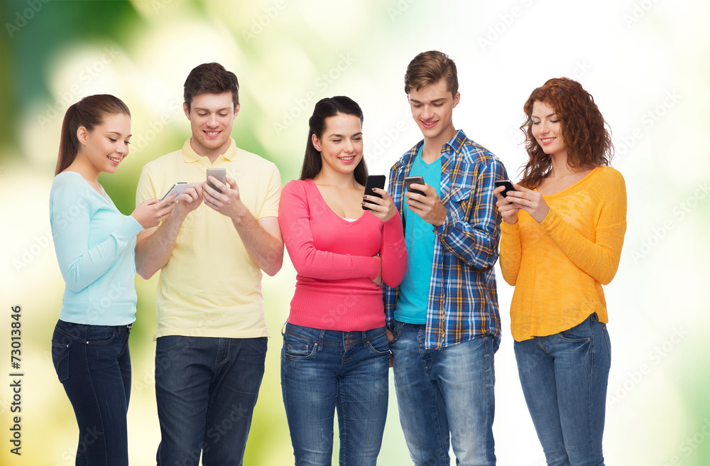 group of smiling teenagers with smartphones group of smiling teenagers with smartphones