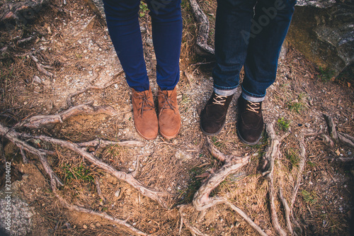 Couple Man and Woman Feet in forest nature background. Fashion t