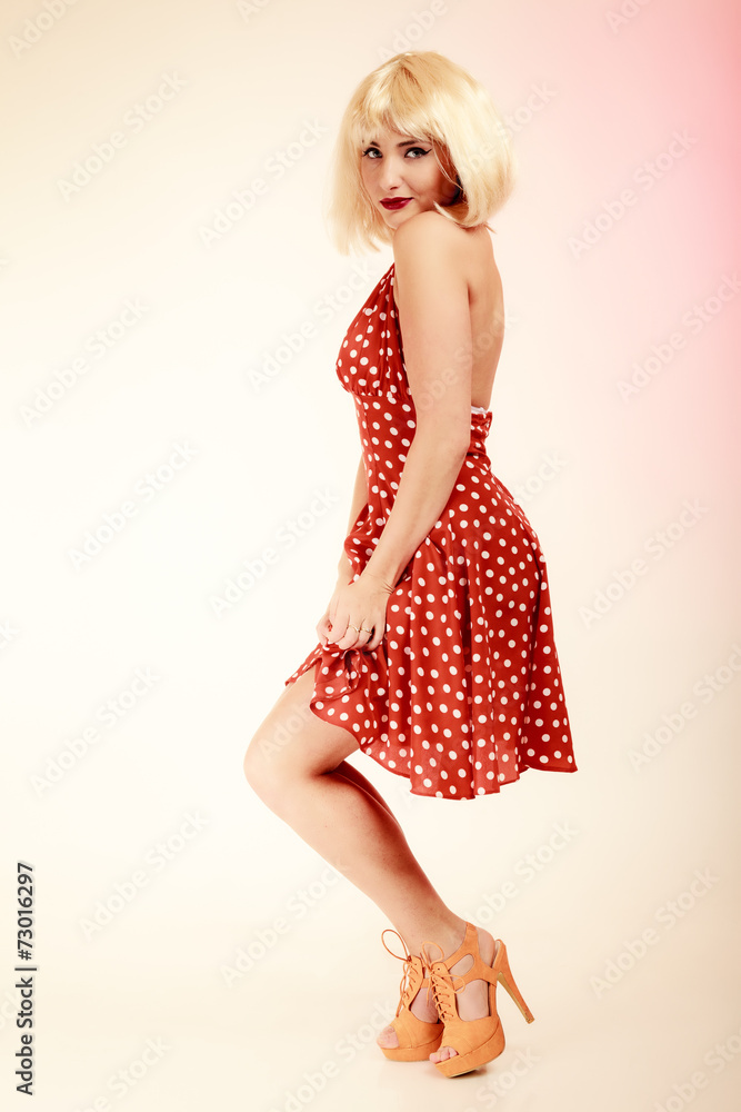 Pinup girl in blond wig and retro dress. Vintage. Pinup girl in blond wig and retro dress. Vintage.