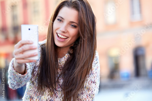 Wallpaper Mural pretty young woman taking a picture on town Torontodigital.ca