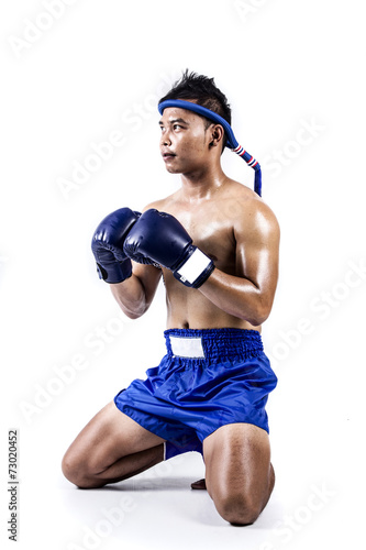 Thai boxer with thai boxing action, isolated on white background