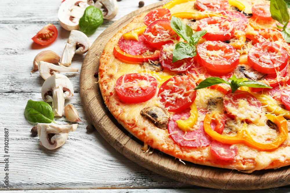 Delicious pizza served on wooden table Delicious pizza served on wooden table