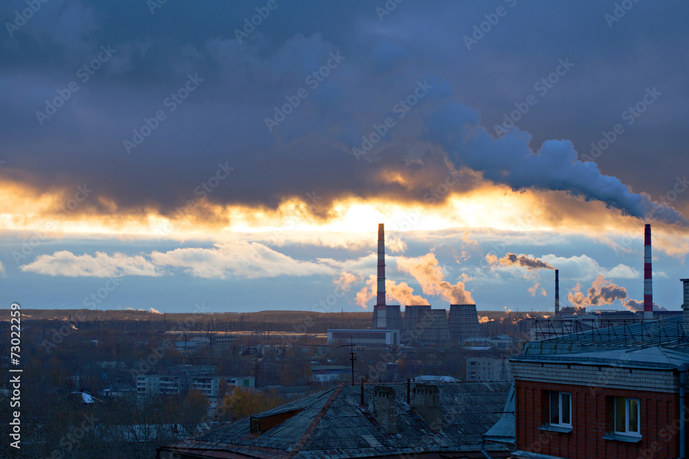 Power plant seen above residential blocks of city