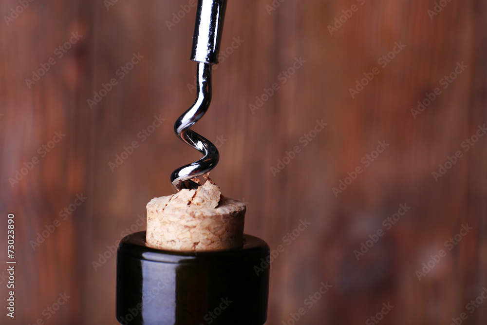 Bottle opener close-up, on wooden background Bottle opener close-up, on wooden background