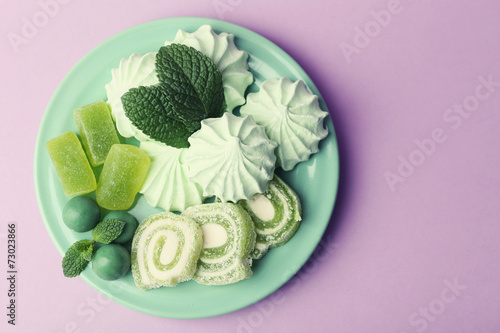 Mint color meringues, mint candies and tasty cake