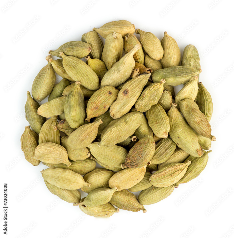 Aerial macro closeup of cardamom pods in a pile isolated against Aerial macro closeup of cardamom pods in a pile isolated against