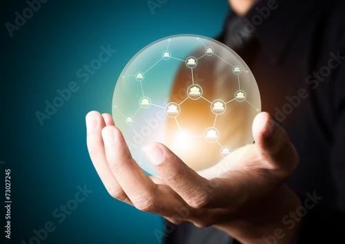 Business people holding social network in crystal ball