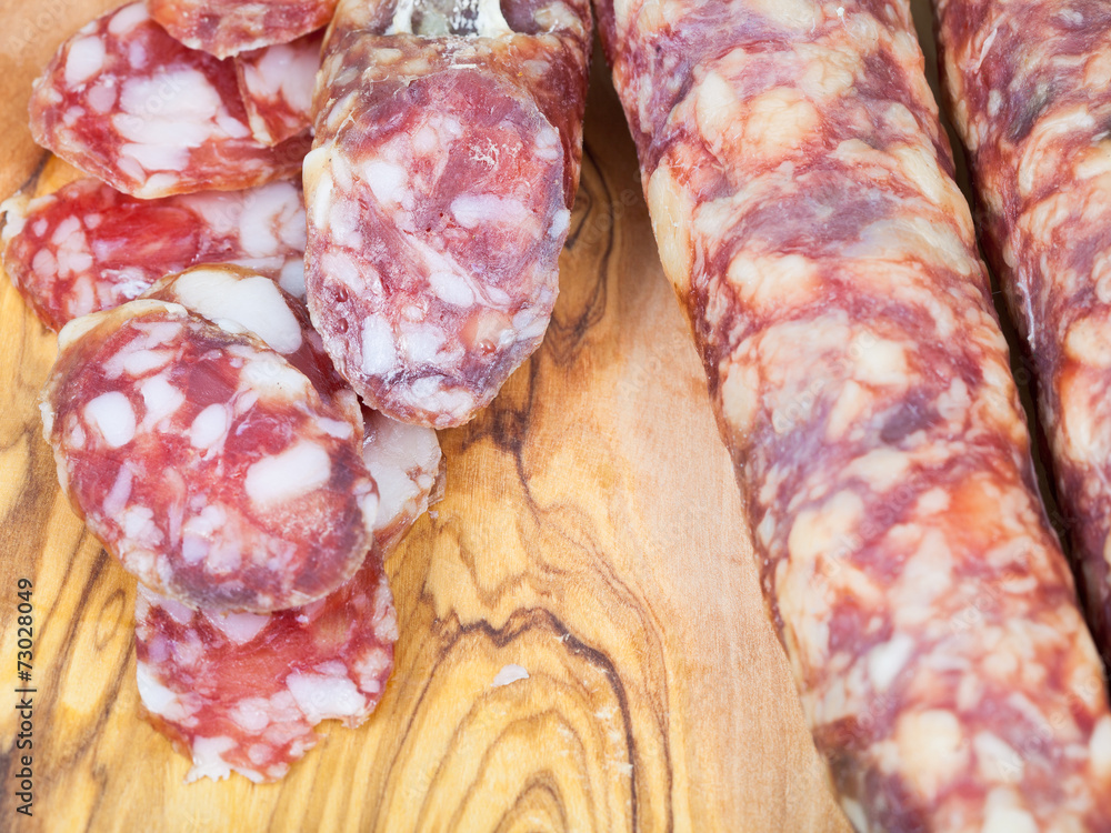 sliced sausage on wooden board close up sliced sausage on wooden board close up